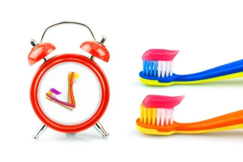 Composition from clock, toothbrushes with toothpaste Stock Photos