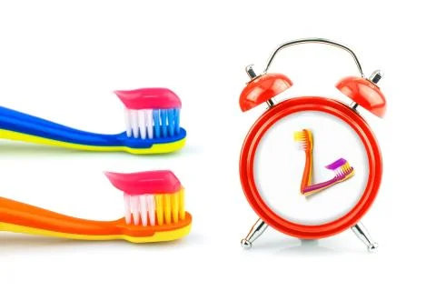 Composition from clock, toothbrushes with toothpaste Stock Photos