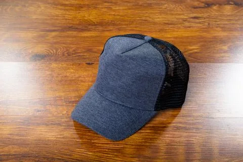 Composition of close up of grey and black baseball cap on wooden background Stock Photos