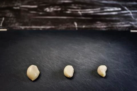 A composition of cloves of garlic on the table. Healthy eating. Stock Photos