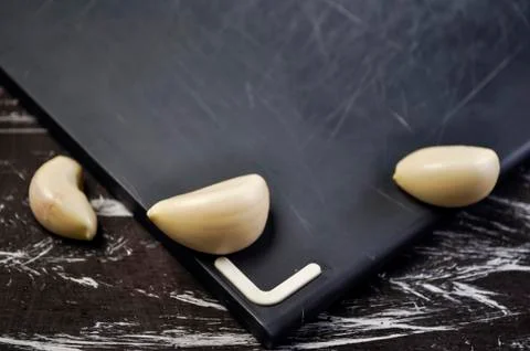 A composition of cloves of garlic on the table. Healthy eating. Stock Photos