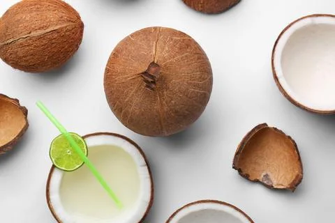 Composition with coconuts and drink on white background, top view Stock Photos