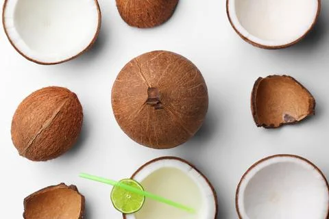 Composition with coconuts and drink on white background, top view Stock Photos
