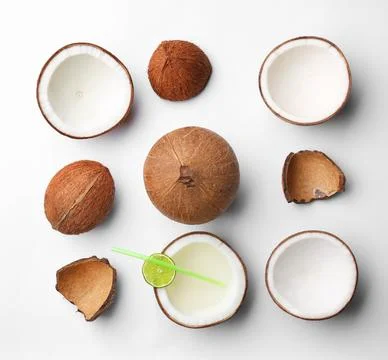 Composition with coconuts and drink on white background, top view Stock Photos