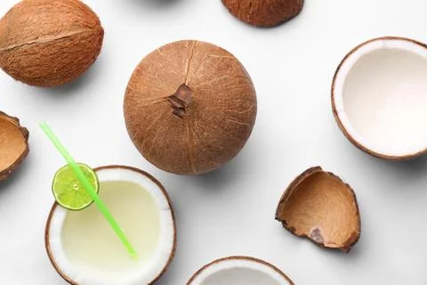 Composition with coconuts and drink on white background, top view Stock Photos