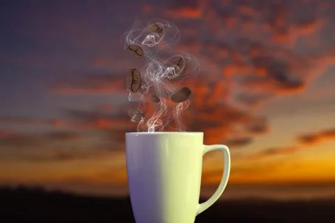 Composition of coffee beans falling inside cup of hot coffee on a beautiful s 库存照片