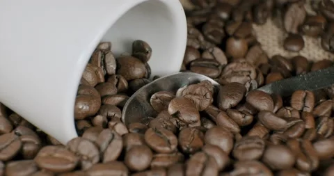 Composition of coffee beans silver spoon and a white cup 動画素材 232257584