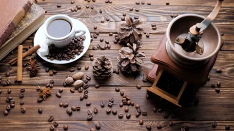 Composition of the coffee grinder and cup of coffee on a wooden background. Stock Footage 130254183