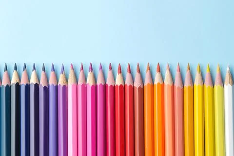 Composition with colored pencils on a bright blue background. top view. space Stock Photos