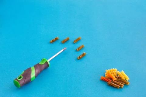 Composition of colored spirals and screwdriver on eye-catching background Stock Photos