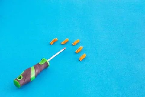 Composition of colored spirals and screwdriver on eye-catching background Stock Photos