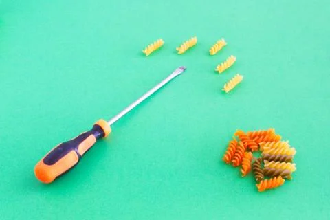 Composition of colored spirals and screwdriver on eye-catching background Stock Photos