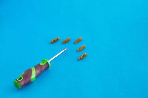 Composition of colored spirals and screwdriver on eye-catching background Stock Photos