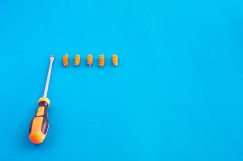 Composition of colored spirals and screwdriver on eye-catching background Stock Photos