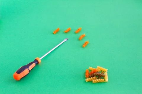 Composition of colored spirals and screwdriver on eye-catching background Stock Photos