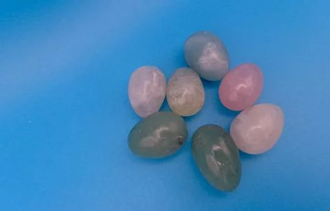 Composition of colored stones on turquoise background Stock Photos