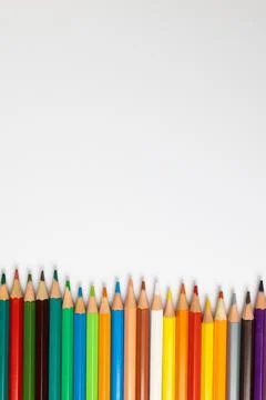 Composition of colorful crayons on white surface with copy space Stockfoto's