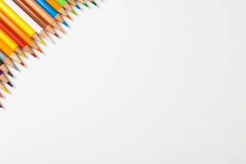 Composition of colorful crayons on white surface with copy space Stock Photos