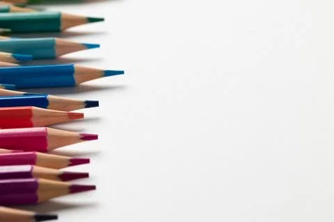 Composition of colorful crayons on white surface with copy space Stock Photos