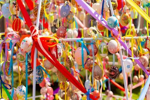 A composition of colorful Easter eggs handing with the multi colored ribbons. A Stock Photos