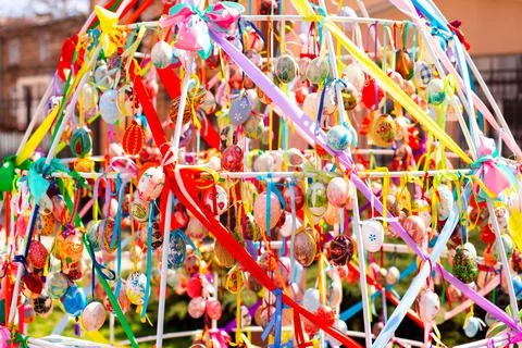 A composition of colorful Easter eggs handing with the multi colored ribbons. A Stock Photos