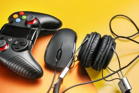 Composition with computer mouse and gaming gear on color background Stock Photos
