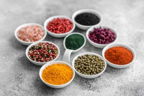 Composition consisting of a variation of several types of spices in white cer Stock Photos