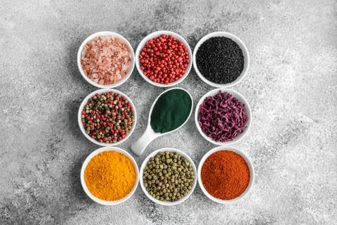 Composition consisting of a variation of several types of spices in white cer Stock Photos