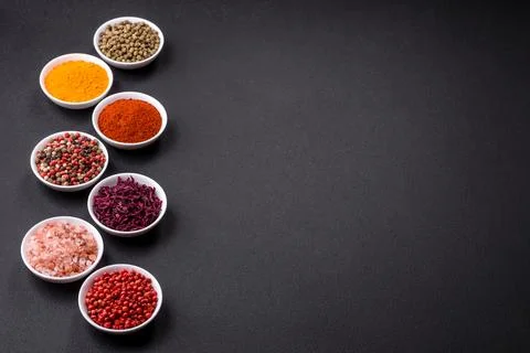 Composition consisting of a variation of several types of spices in white cer Stock Photos