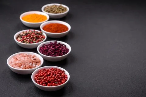 Composition consisting of a variation of several types of spices in white cer Stock Photos