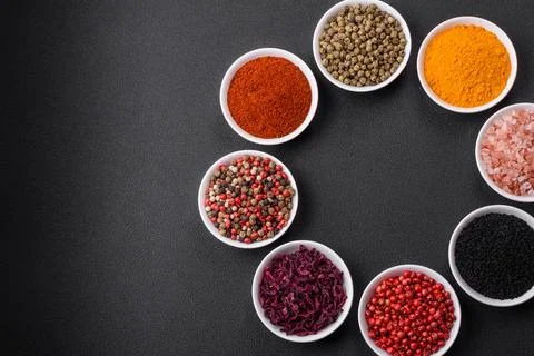 Composition consisting of a variation of several types of spices in white cer Stock Photos