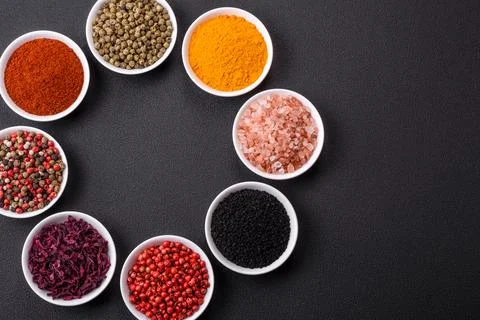 Composition consisting of a variation of several types of spices in white cer Stock Photos