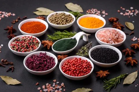 Composition consisting of a variation of several types of spices in white cer Stock Photos
