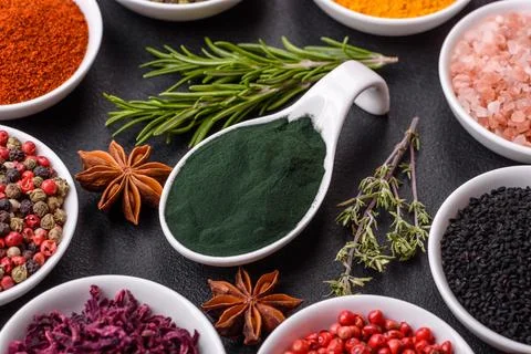 Composition consisting of a variation of several types of spices in white cer Stock Photos