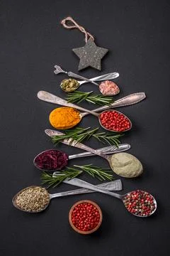Composition consisting of a variation of spices in metal spoons laid out in.. Stock Photos