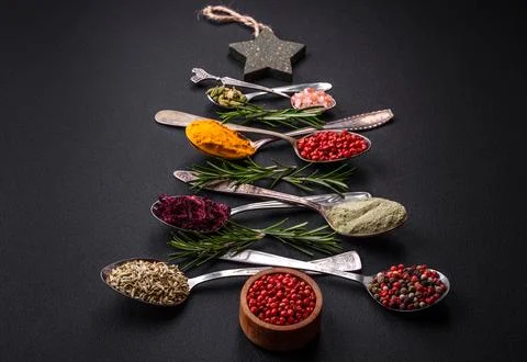 Composition consisting of a variation of spices in metal spoons laid out in.. Stock Photos