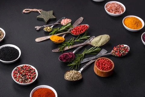 Composition consisting of a variation of spices in metal spoons laid out in.. Stock Photos