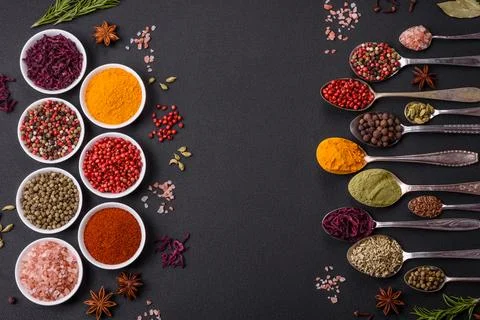 Composition consisting of variations of spices in white bowls and metal spoon Stock Photos