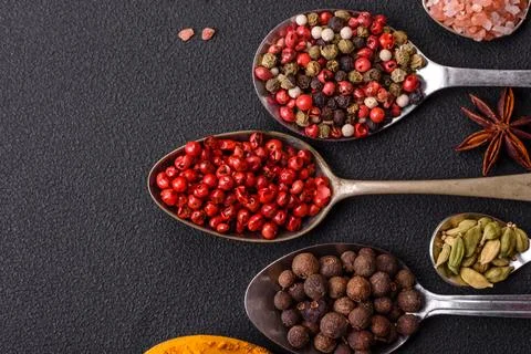 Composition consisting of variations of spices in white bowls and metal spoon Stock Photos