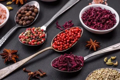 Composition consisting of variations of spices in white bowls and metal spoon Stock Photos