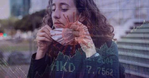 Composition of covid 19 cell and medical data processing over caucasian woman Foto stock