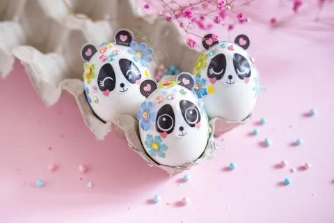 A composition with creatively colored Easter eggs with panda stickers and a b Foto stock