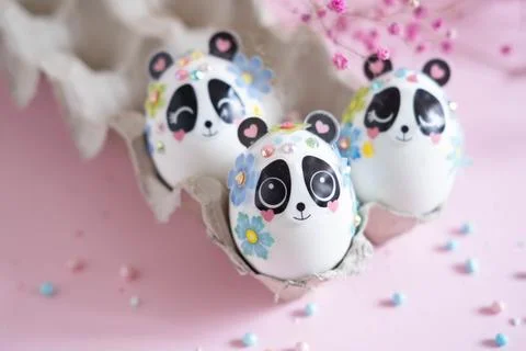 A composition with creatively colored Easter eggs with panda stickers and a Foto stock