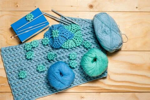 Composition of crocheted blue-green openwork napkins and equipment for knitti Stock Photos
