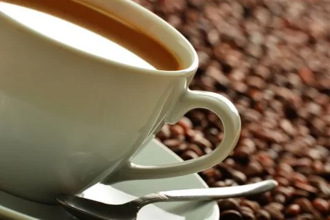 Composition with cup and coffee beans Stock Photos