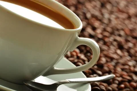 Composition with cup and coffee beans Photos