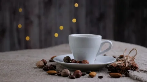 Composition of the cup of coffee with beans of coffee rotating on sackcloth. Stock Footage 130254668