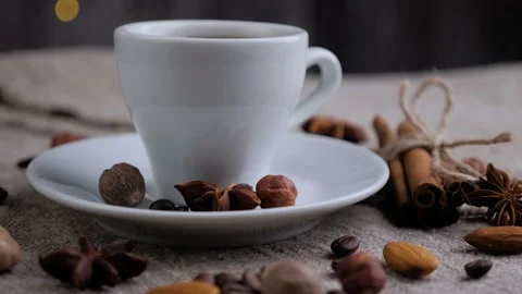 Composition of the cup of coffee with beans of coffee rotating on sackcloth. Stock Footage 131005511