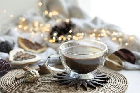 Composition with a cup of coffee on a blurred background with a knitted element. Stock Photos