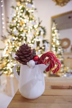 Composition with cup of hot drink, candy canes and Christmas tree background Stock Photos
